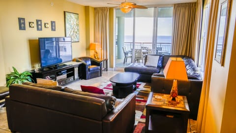 An inviting living room with 100" TV and view of the beach for your enjoyment.