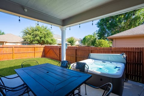 Relax and dine outdoors in the private hot tub area.