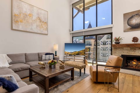 Step into your light-filled living space where comfort meets modern design. Relax on the plush sofa by the warm fireplace or take in the cityscape through soaring windows.