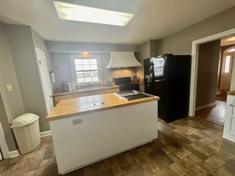 kitchen with island, microwave, refrigerator, gas range, dishwasher