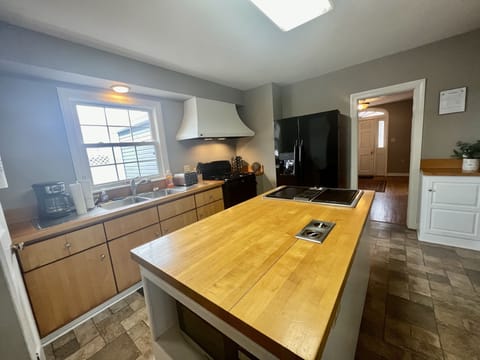 Island, Side by side refrigerator with ice maker and gas stove in the kitchen