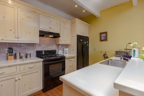 equipped kitchen with whitewashed pine cabinetry