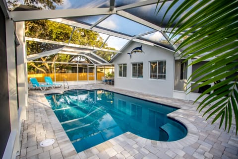 Outdoor living with screened heated pool and adjacent BBQ porch