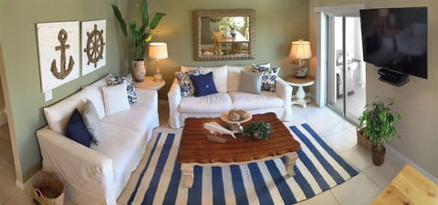 Living Room has South facing Balcony with indirect partial ocean view.