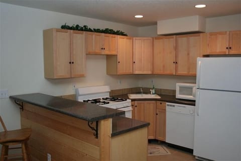 Second full kitchen in game room with raised bar.