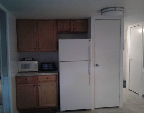 Opposite side of kitchen - fridge, microwave, toaster oven 
