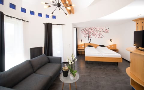 Junior Suite | Living area | 28-inch flat-screen TV with cable channels, TV, toys