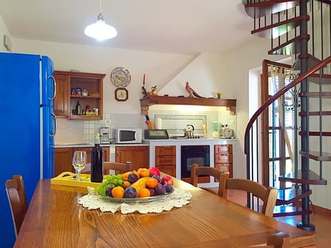 Kitchen with door to the verandah and to the outside.Spiral stairs to 1st floor