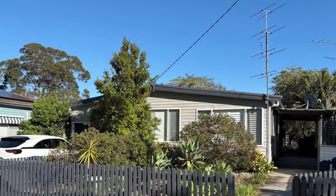 Front of house with parking in the driveway.