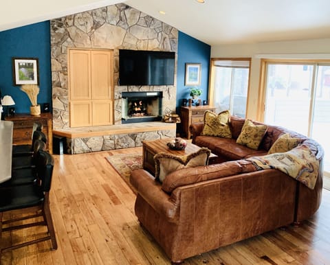 Great Room with cozy fireplace next to the kitchen and dining room