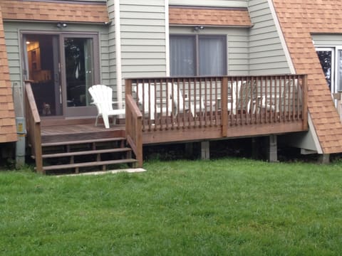 Back deck with level yard for games (cornhole boards and bags in unit)