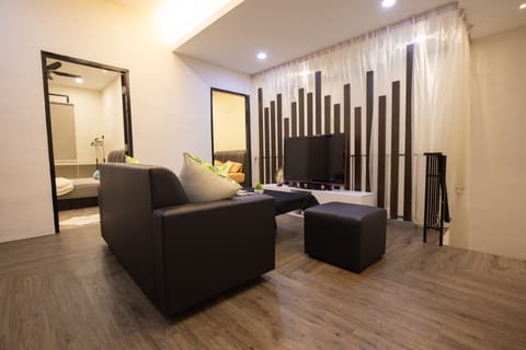 4 Bedroom Apartment | Living area | 50-inch flat-screen TV with digital channels, TV