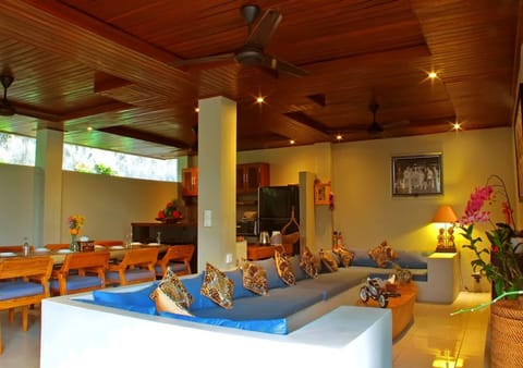 Lower common (TV) area with kitchen & dining area in background