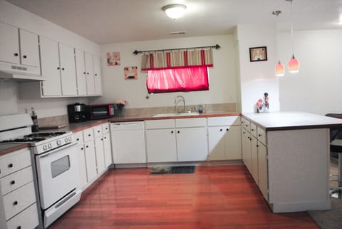 Full kitchen with pots, pans, plates, cups, silverware, coffee maker, microwave.