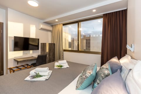 Deluxe Double or Twin Room, City View | Minibar, in-room safe, desk, iron/ironing board