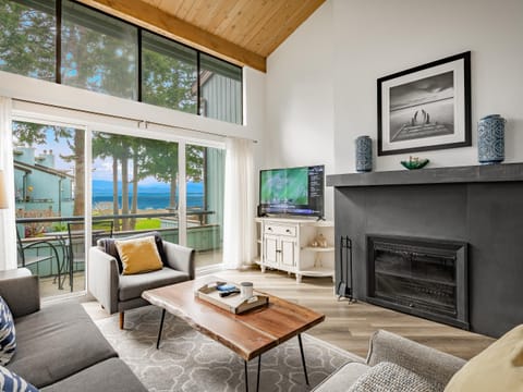Living room with panoramic ocean views and cozy fireplace