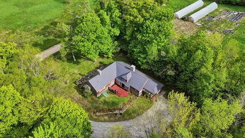 Aerial of the farmhouse and red metal roof