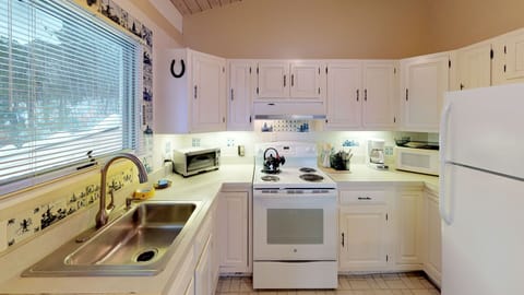 Upper level kitchen view showing the sink, counter space, and cooking area.