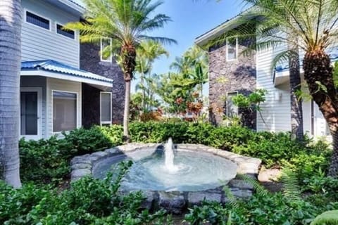 Soothing fountain at your doorstep. Fountains add to the condo tropical feeling