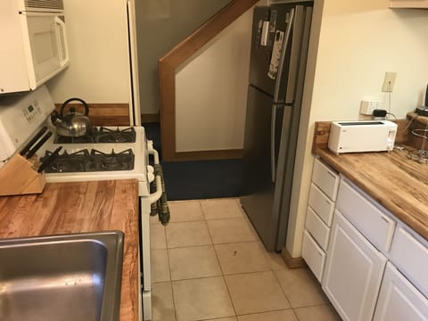 Kitchen with Gas Stove, Large Sink, Microwave, and Oven.