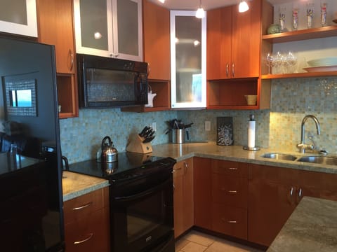 Glass stove top and over range microwave.