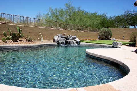 Private backyard with pool and putting green