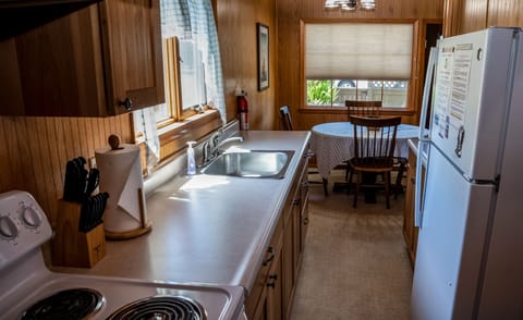 Galley kitchen with full sized appliances including a coffee maker and microwave