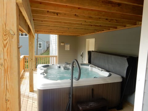 8' by 8' jetted hot tub with water falls, hand rail and seats 7 adults