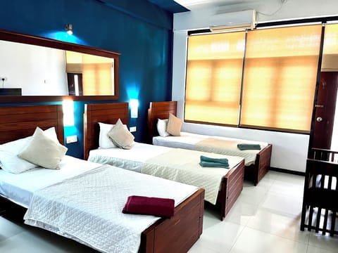Deluxe Triple Room | Desk, blackout drapes, iron/ironing board, WiFi (free)