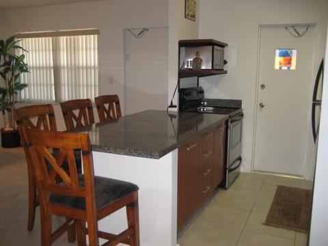Kitchen with stove/oven and microwave view