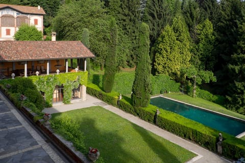 View of the pool, outdoor dining portico, garden and terrace from bedroom 1
