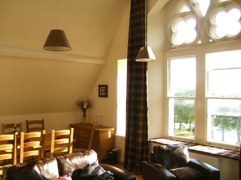 The living room with window seat and dining table