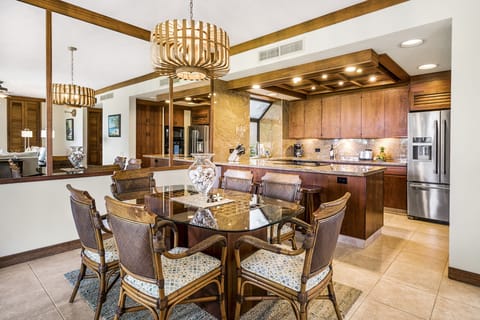 Dining Table, Chairs, and the Kitchen with Refrigerator and Coffee Maker