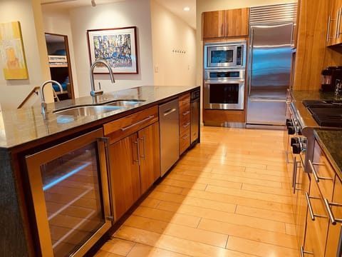 A Sub-Zero refrigerator, beverage chiller and gas stove make meal prep easy.