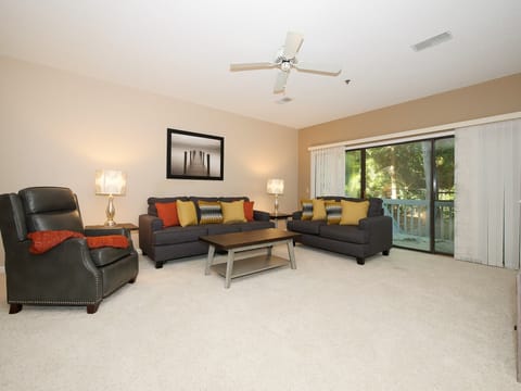 Ocean Breeze 100 - Living Area - Located off the living area is a nice sized deck with electric grill with a quiet and private wooded view.
