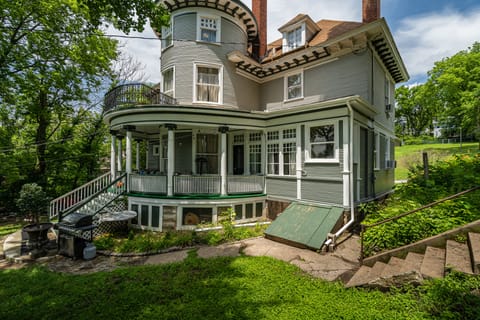View of Mansion from backyard.  Note circle porch, Juliet balcony, tower rooms.
