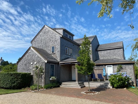 Front of house with sundeck and outdoor shower