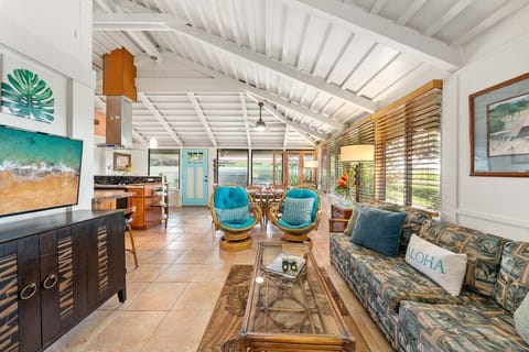 Enjoy a cozy lounge area with tropical accents and easy access to the outdoors
