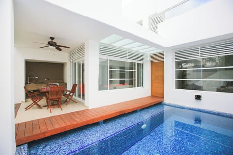 The view of the entrance, BBQ corner and pool