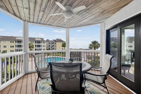 Enjoy your morning coffee with sweeping views of the pool, palm trees, and shimmering waterfront. This covered balcony offers a breezy retreat where you can relax at any hour.