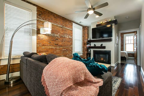 Living room with pull out couch, fireplace and tv.