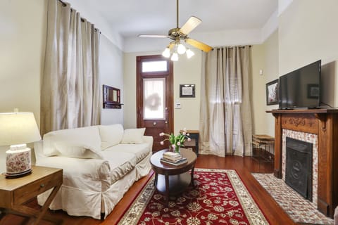 Living room with queen sofa sleeper and large flat screen TV.