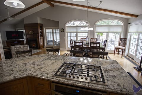 Wall of windows from kitchen and living area opens to deck and wonderful views