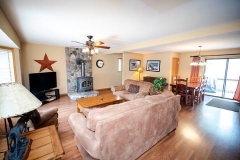 Spacious living room with cozy fireplace and mountain charm