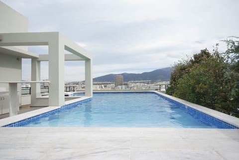 Private swimming pool at roof garden with panoramic city view