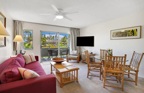 The sunny living room is naturally cooled by ocean breezes ... or fan and A/C.