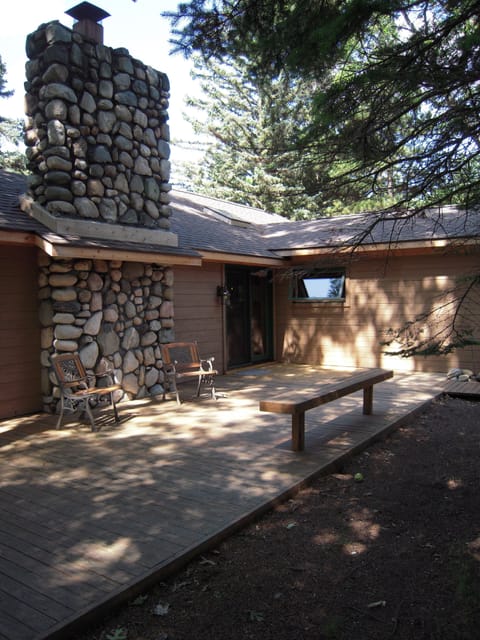 Stone fireplace accents entry to cottage off circle drive.