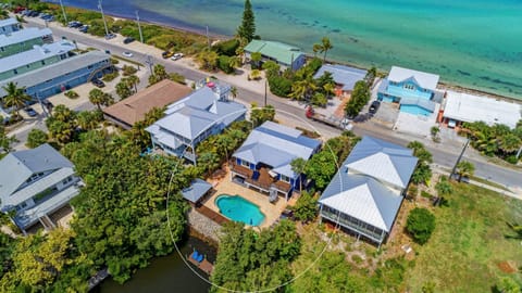 Private Separate Tiki Bar, No reason to ever leave home! 10 Resort Style Chaise Lounges, Dining for 16. SW Exposure for Sun Lovers! 20 degrees warmer than anywhere else on the island in the pool area. Canal direct access.