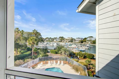 Beautiful marina views with boats and tropical landscape create a peaceful waterfront setting perfect for relaxation.