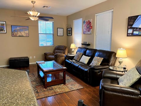 Spacious Livingroom with leather sofa (recliners built in) and 2 recliners.